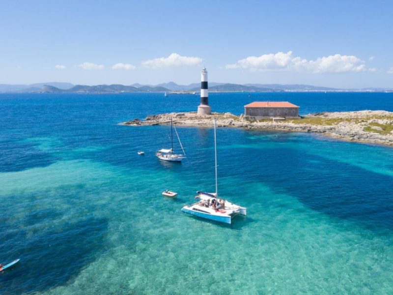 boat aventura 28 anchored in s´illa des porcs in the island of espalmador during a clear day of summer